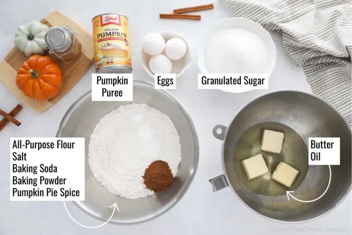 Pumpkin bundt cake ingredients in bowls and cans, labeled. Pumpkin puree, eggs, granulated sugar, all-purpose flour, salt, baking soda, baking powder, pumpkin pie spice, butter, and oil.