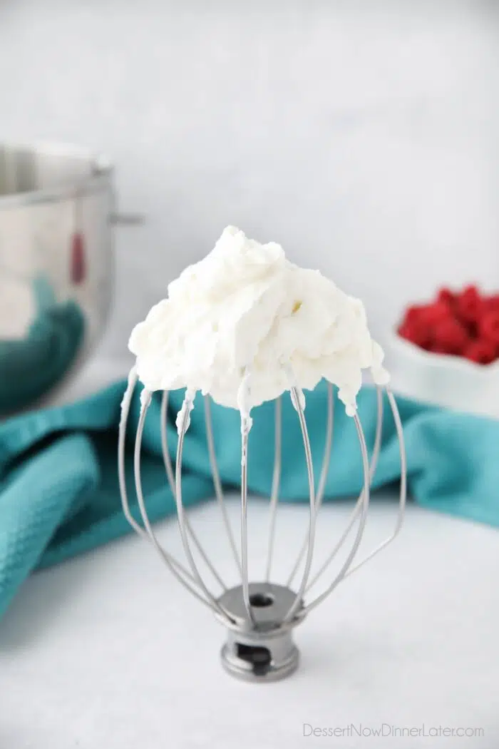 Whisk attachment with stabilized whipped cream on it.