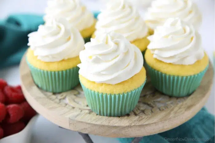 Zoomed in on cupcakes with whipped cream frosting piped high.