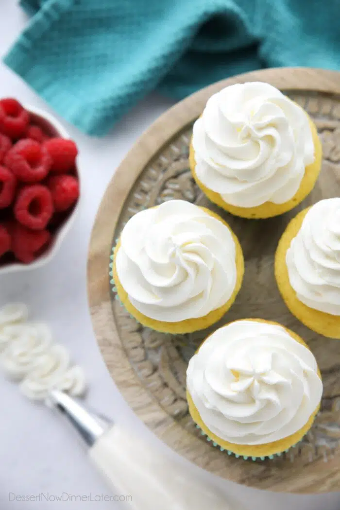 Top view of cupcakes piped with whipped cream frosting.