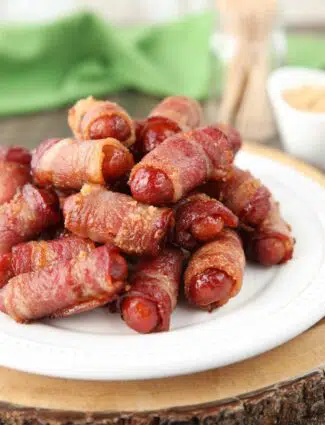 Plate of bacon wrapped smokies with brown sugar.