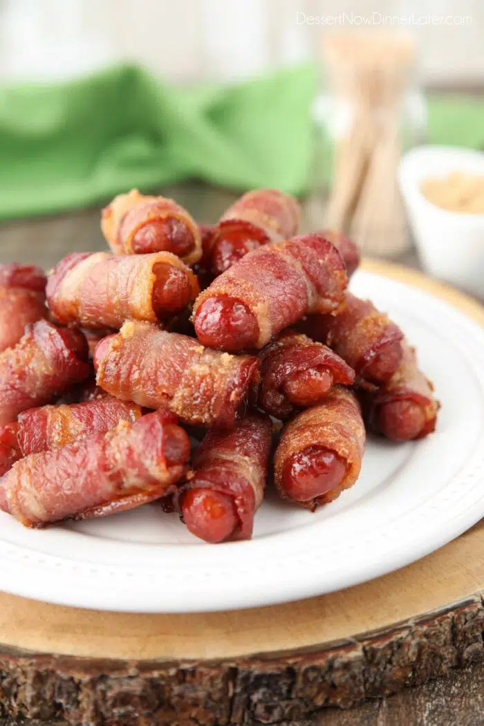 Plate of bacon wrapped smokies with brown sugar.