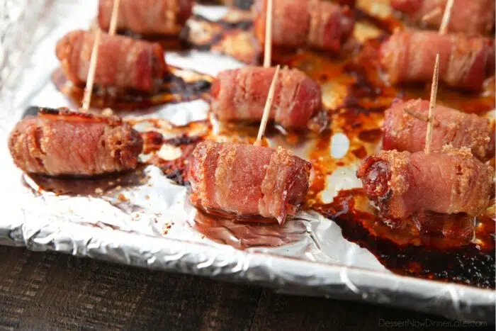 Close up of baked smokies with bacon and brown sugar just out of the oven.