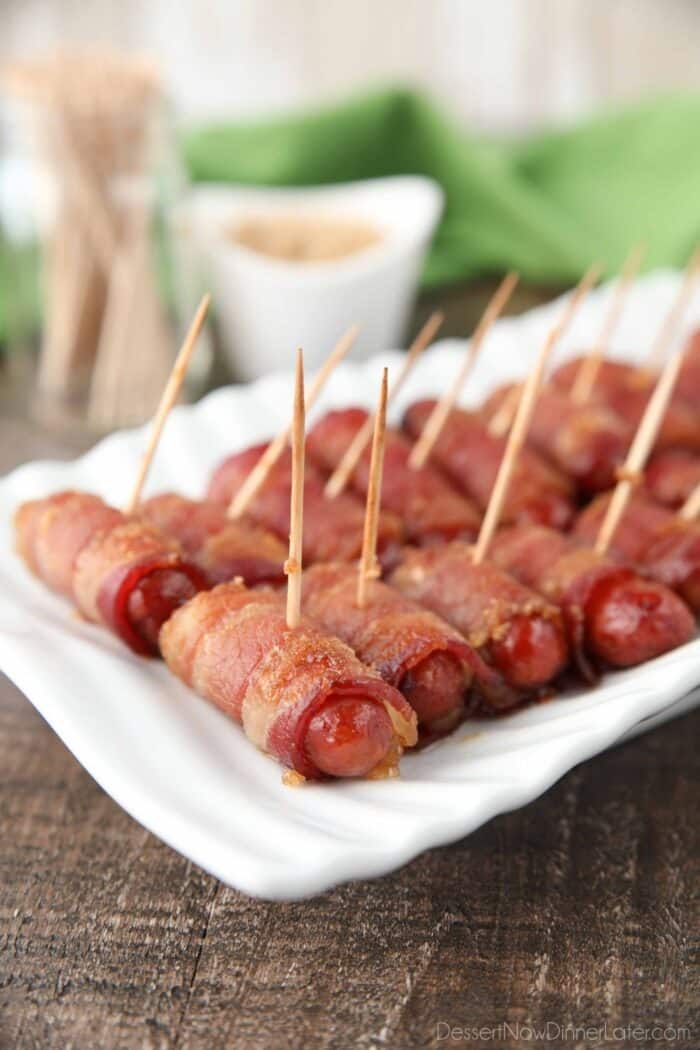 Bacon wrapped little smokies with toothpicks inserted for serving.