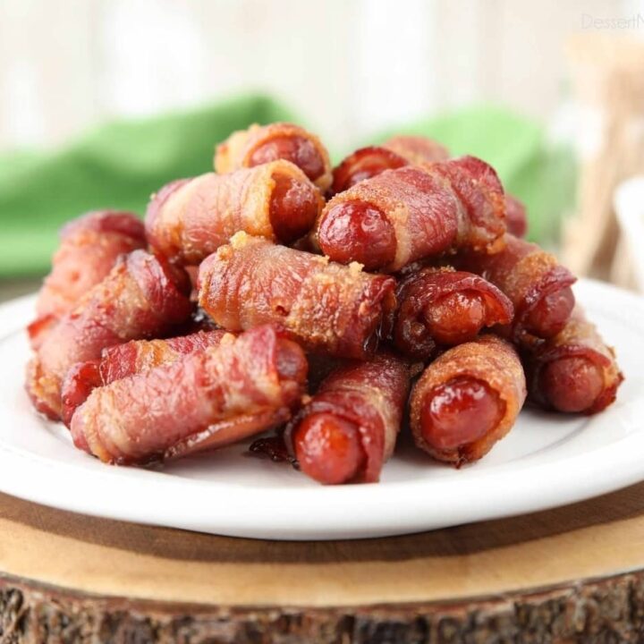 Pile of bacon wrapped smokies on a plate.