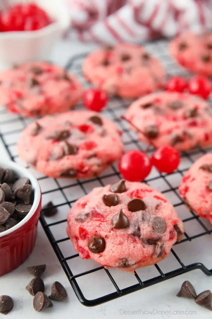 Side view of chocolate chip cherry cookies on a cooling rack.