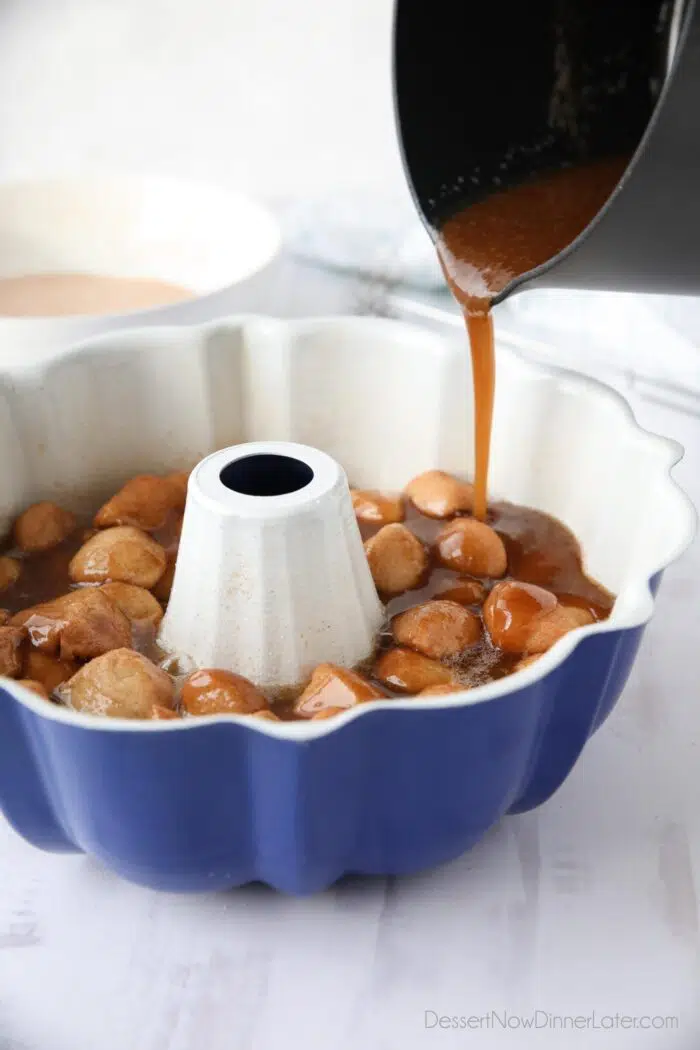Pouring caramel syrup over dough pieces in bundt pan.