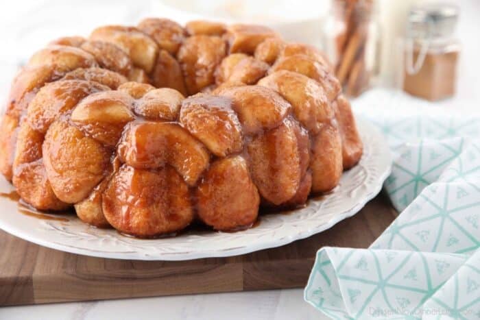 Side view of caramelized monkey bread on a plate.