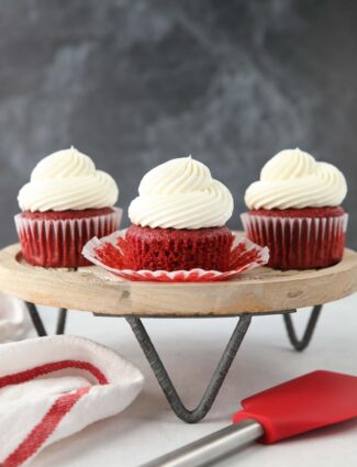 Red Velvet Cupcakes with cream cheese frosting on a cake stand.
