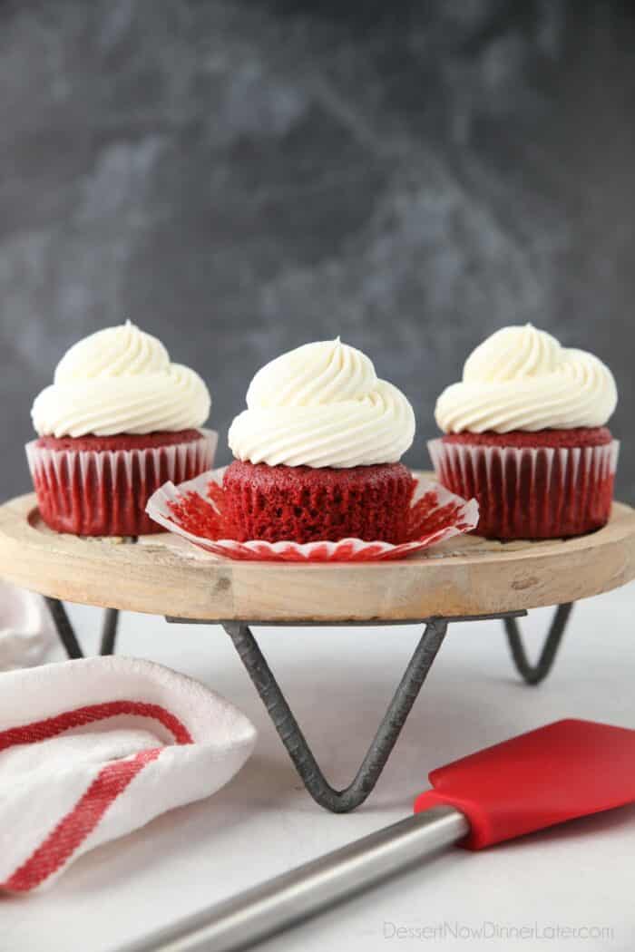 Red Velvet Cupcakes with cream cheese frosting on a cake stand.
