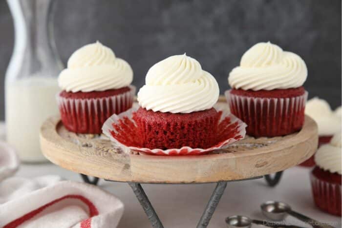 Closeup of a red velvet cupcake with the wrapper pulled down to show the fluffy moist texture.