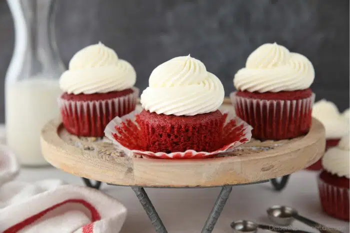 Closeup of a red velvet cupcake with the wrapper pulled down to show the fluffy moist texture.