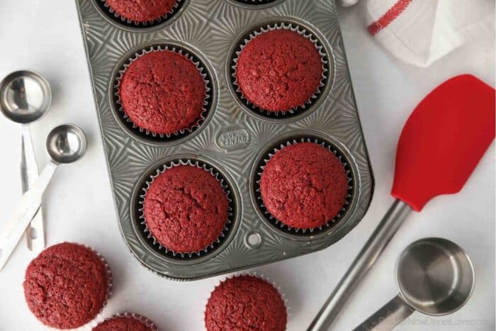 Close up, top view of baked red velvet cupcakes in muffin tin.