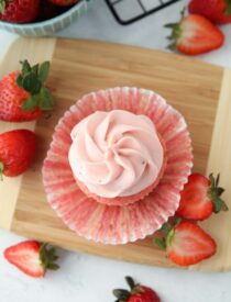 Top view of strawberry cream cheese frosting piped onto the top of a cupcake.