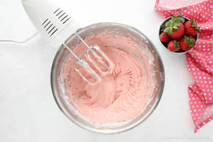 Strawberry Cream Cheese Frosting in mixing bowl with beaters.
