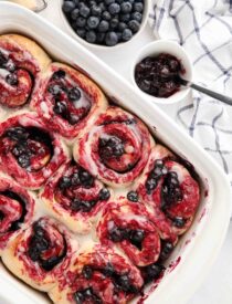 Top view of a baking dish full of blueberry cinnamon rolls.