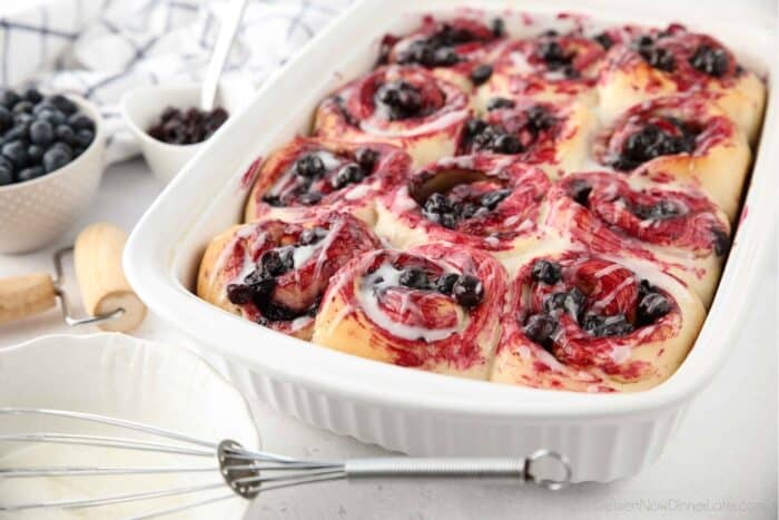 Angled view of casserole dish filled with blueberry cinnamon rolls.