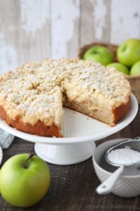 Cake platter with Irish apple cake and a slice taken out.