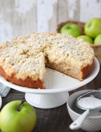 Cake platter with Irish apple cake and a slice taken out.