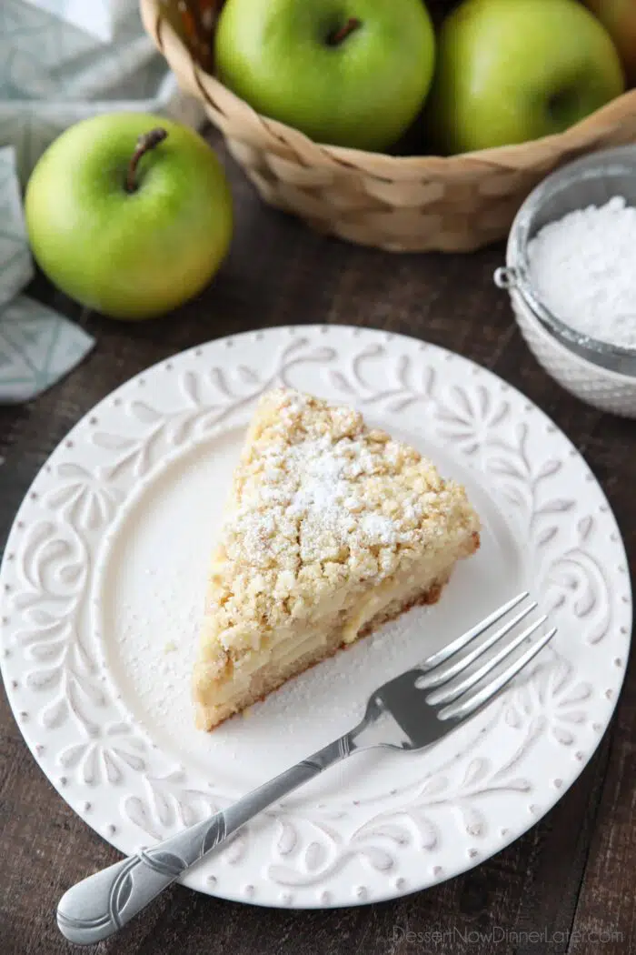 Top view of a slice of apple crumb cake on a plate.