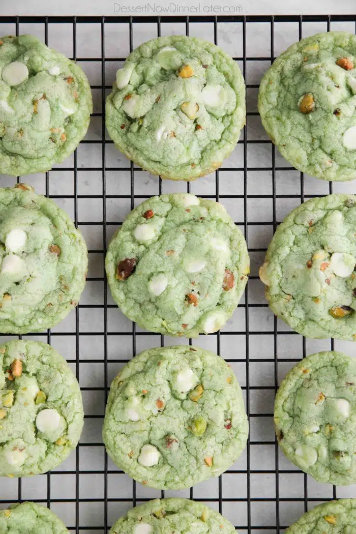 Baked pistachio pudding cookies on a wire cooling rack.