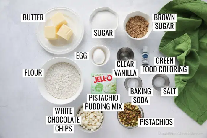 Ingredients for Pistachio Pudding Cookies: butter, granulated sugar, brown sugar, egg, vanilla, green food coloring, flour, pistachio pudding mix, baking soda, salt, white chocolate chips, and pistachios.