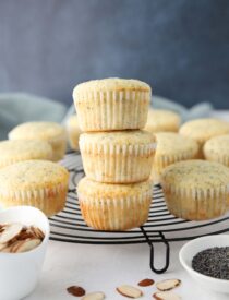 Almond Poppy Seed Muffins stacked on top of each other.