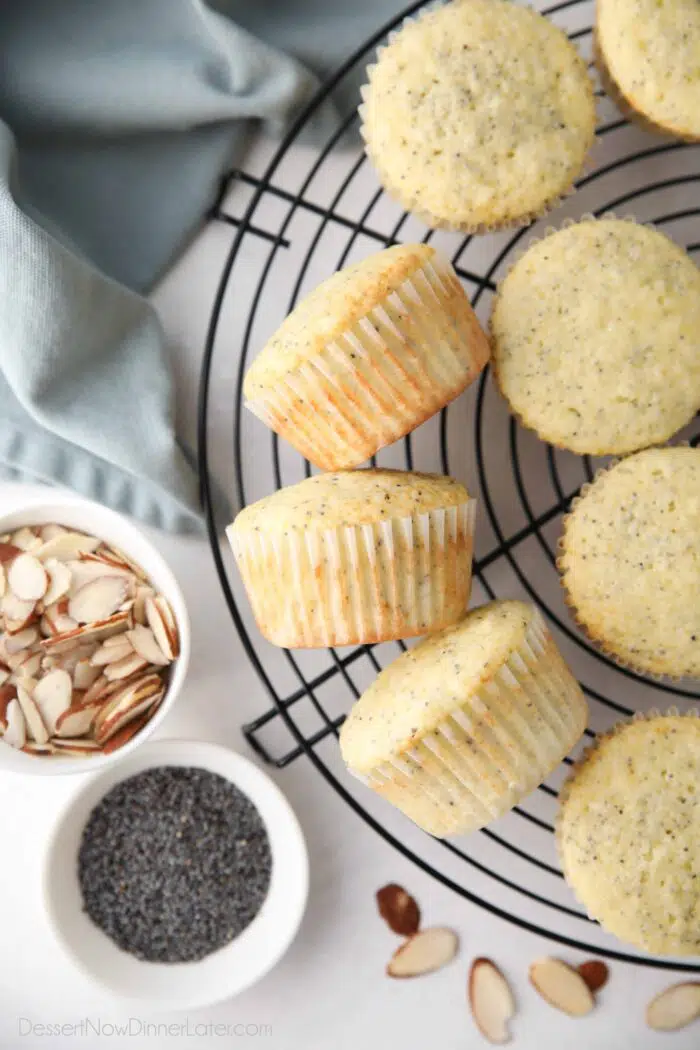 Top view of almond poppy seed muffins resting on a wire cooling rack.