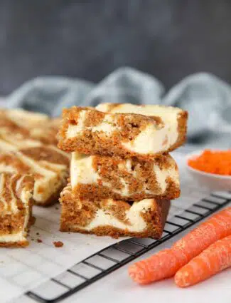 Carrot Cake Cheesecake Bars stacked on top of each other.