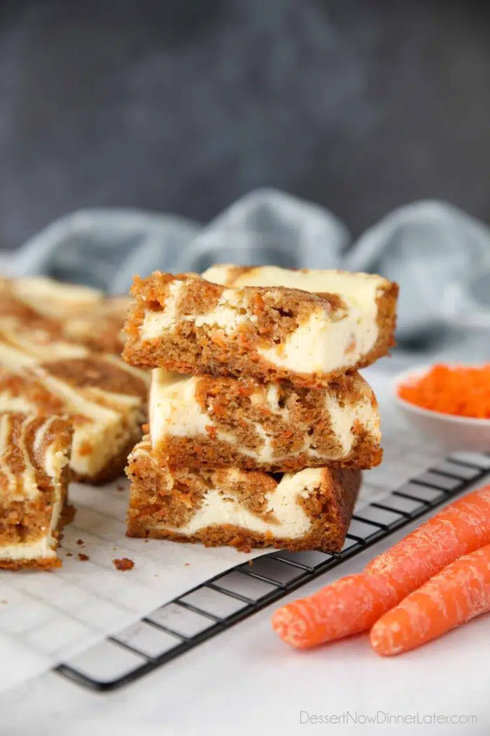 Carrot Cake Cheesecake Bars stacked on top of each other.