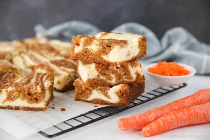 Three Carrot Cake Cream Cheese Bars stacked on top of each other.