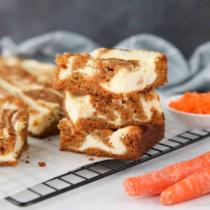 Three Carrot Cake Cream Cheese Bars stacked on top of each other.