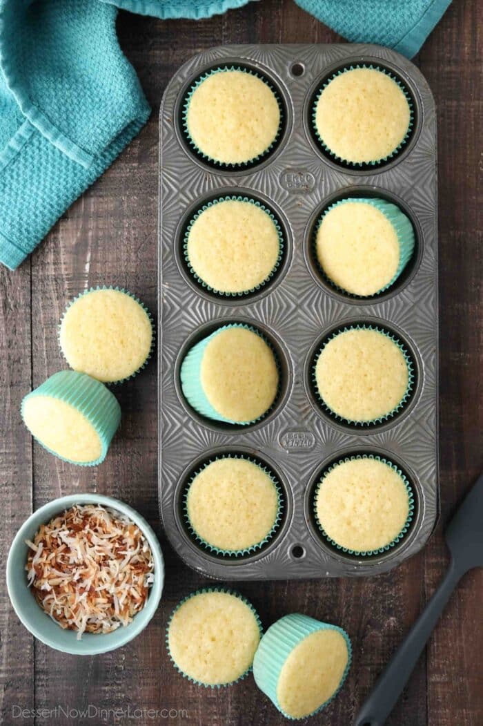 Top view of coconut cupcakes in a tin pan.