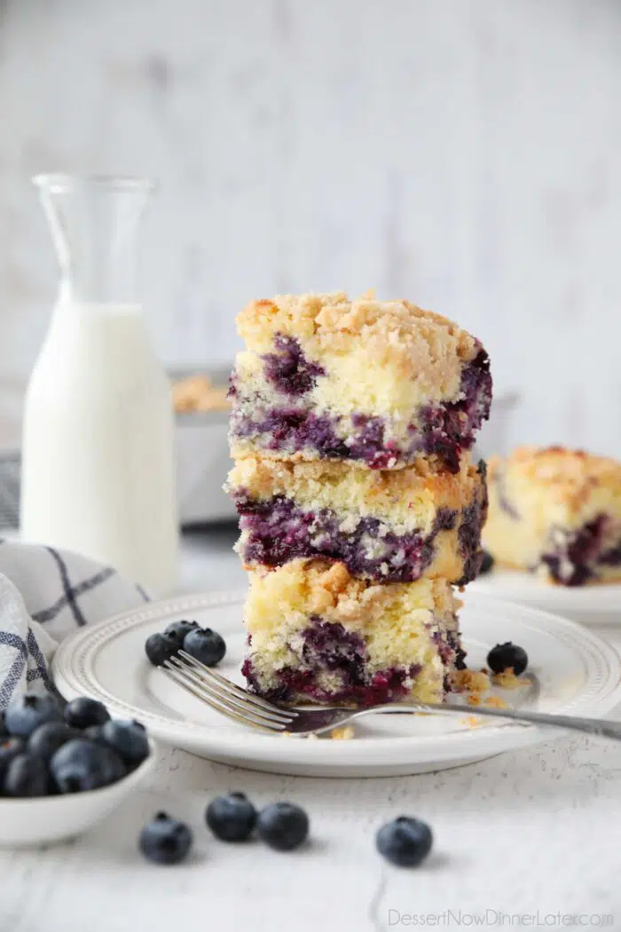 Three slices of blueberry coffee cake stacked on top of each other.