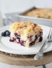 Slice of blueberry streusel coffee cake on a plate.