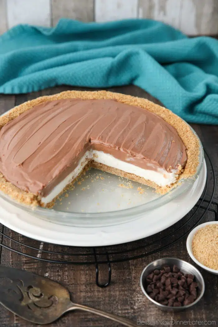 No bake chocolate cream cheese pie in a pan with a couple slices taken out.