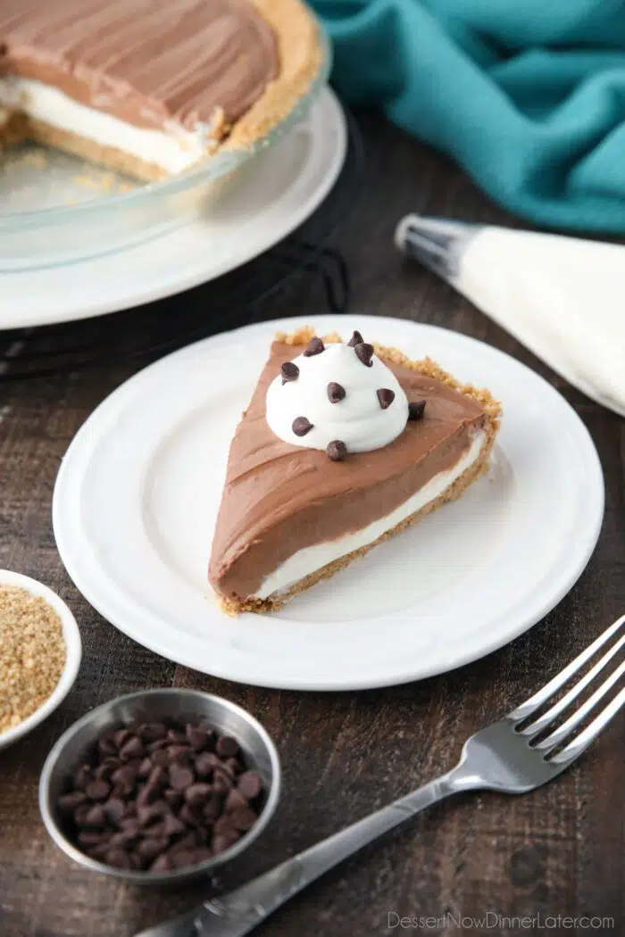 Slice of Chocolate Cream Cheese Pie on a plate with whipped cream and mini chocolate chips.