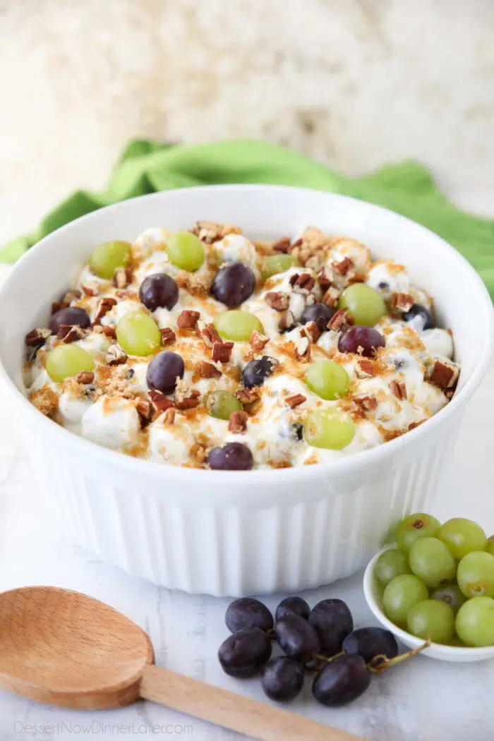 Large serving bowl full of grape salad.