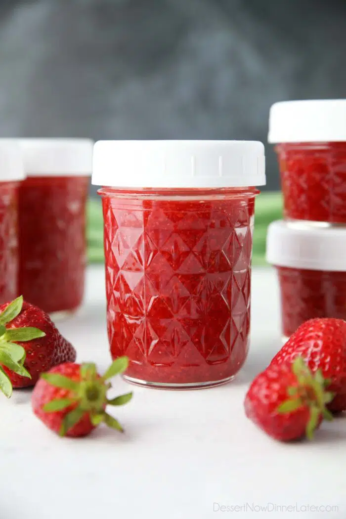 Close-up of a glass jar of homemade strawberry freezer jam.