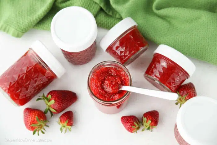 Top view of low-sugar strawberry freezer jam with a spoon inside.