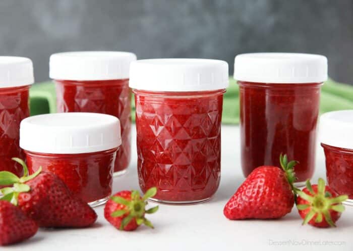 Mason jars filled with homemade strawberry jam.