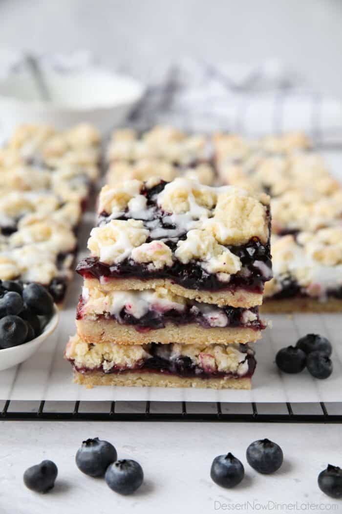 Blueberry pie bars stacked on top of each other.