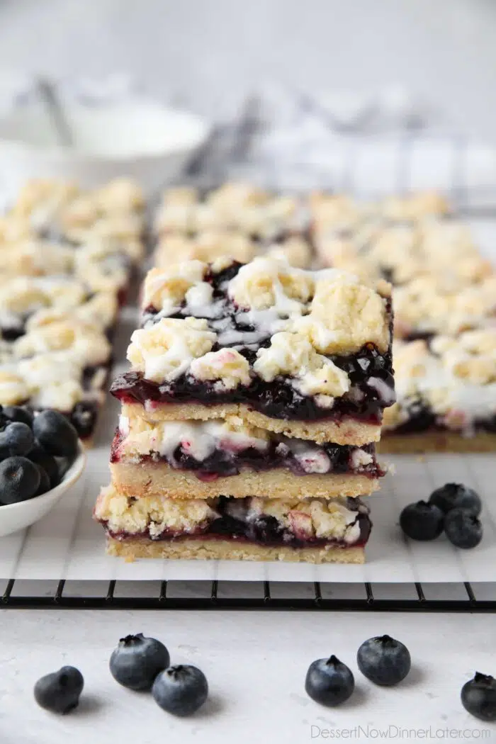Blueberry pie bars stacked on top of each other.