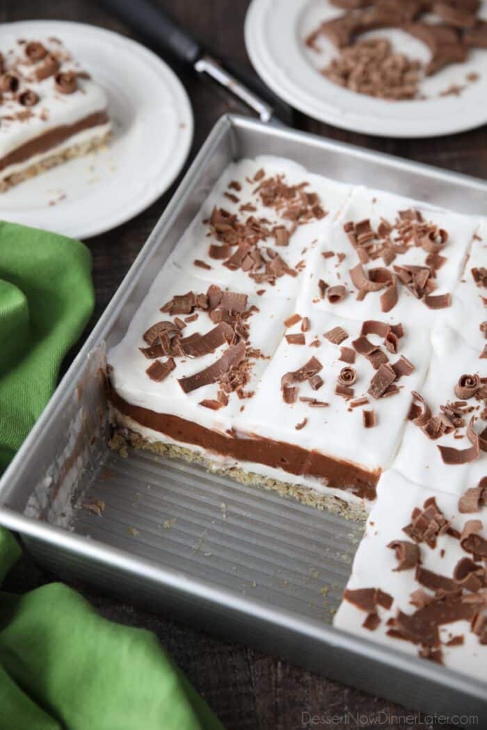 Pan of chocolate delight dessert with two pieces take out.