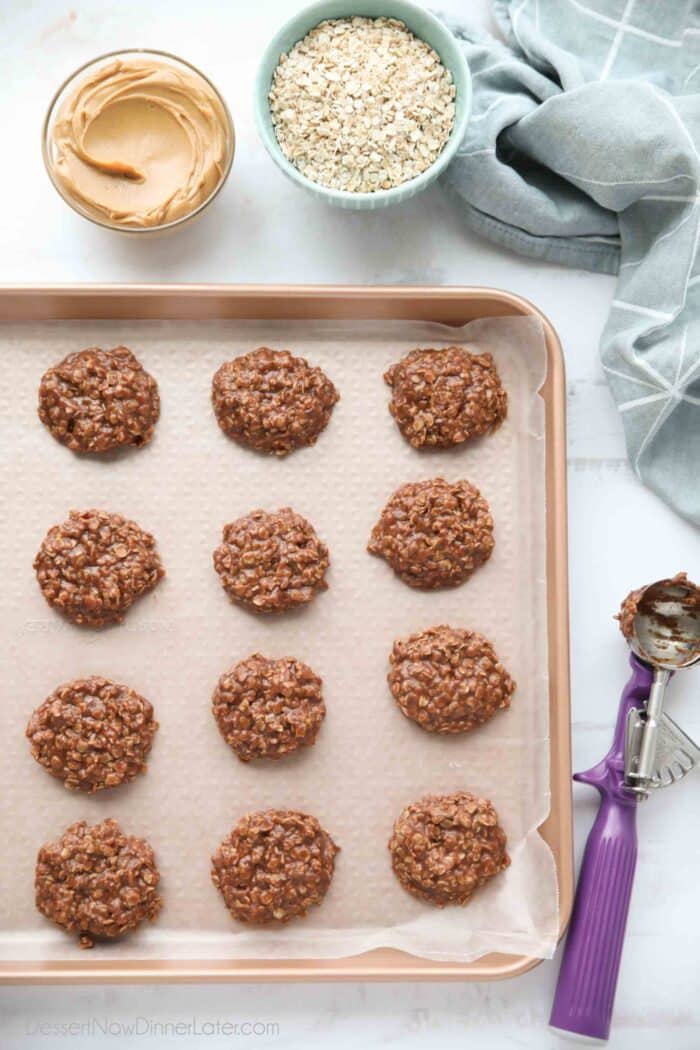 No bake cookies scooped onto a baking sheet with wax paper.