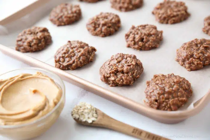 No bake cookies set up on baking tray with wax paper.