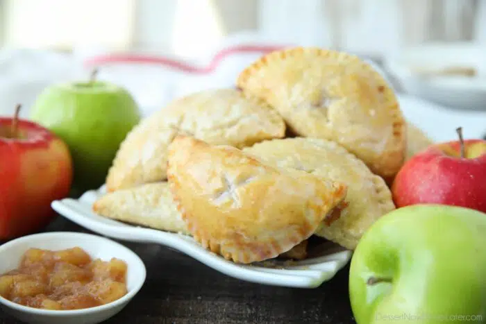 Single-serve apple pies with glaze.