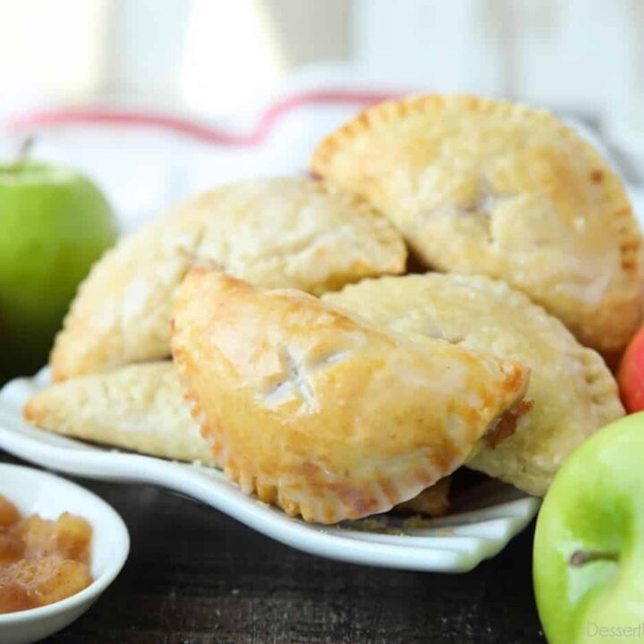 Single-serve apple pies with glaze.