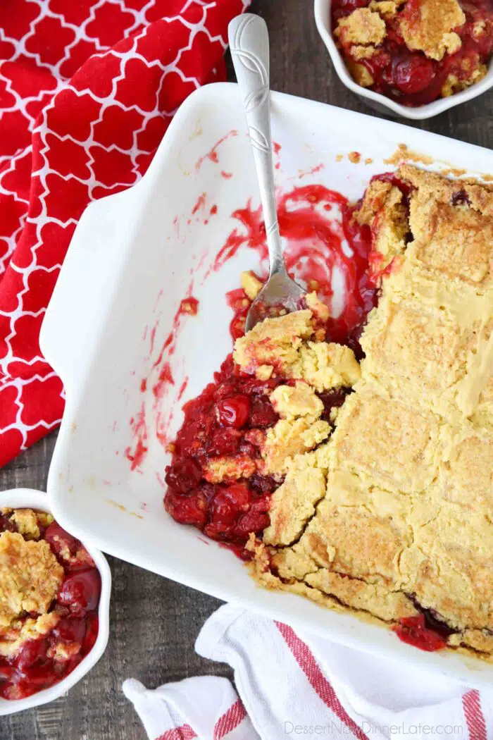 Baking pan of cherry pie filling with yellow cake baked on top. Aka cherry dump cake.