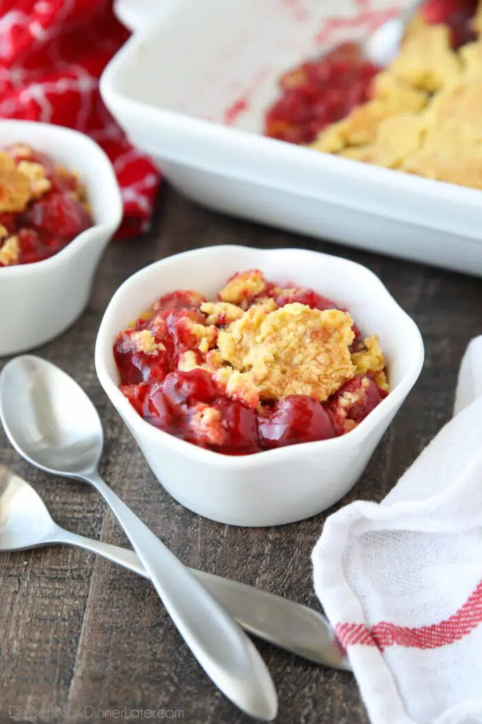 Bowl full of cherry pie filling and yellow cake baked on top.